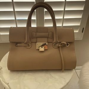 Jimmy Choo neutral camel colored bag.